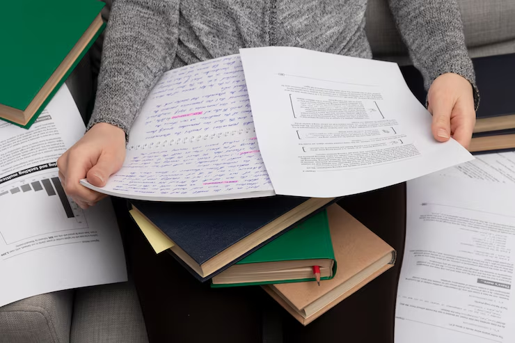 Close-up of Jamia Millia Islamia IAS coaching question paper on a study desk, surrounded by notes and pens — representing exam practice and preparation for UPSC aspirants.