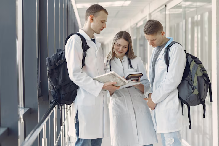 Medical students attending a lecture or practicing in a lab, with books and anatomy models in view — capturing the academic and hands-on experiences of medical school life.