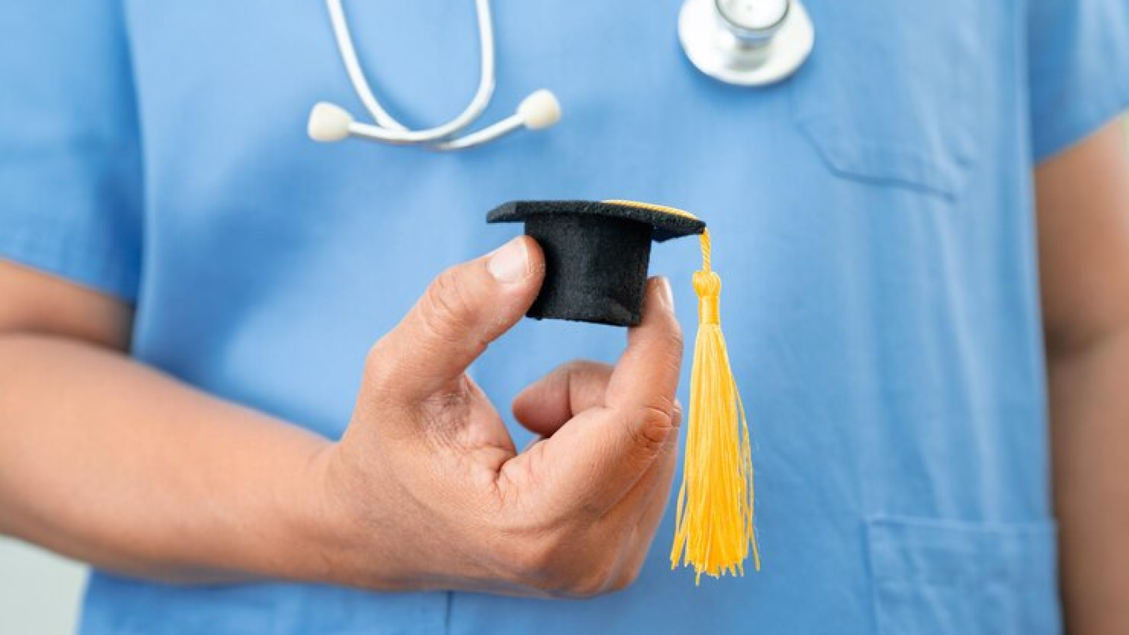Aspiring medical student studying with textbooks and a stethoscope on the desk, symbolizing the journey and steps involved in becoming a doctor.