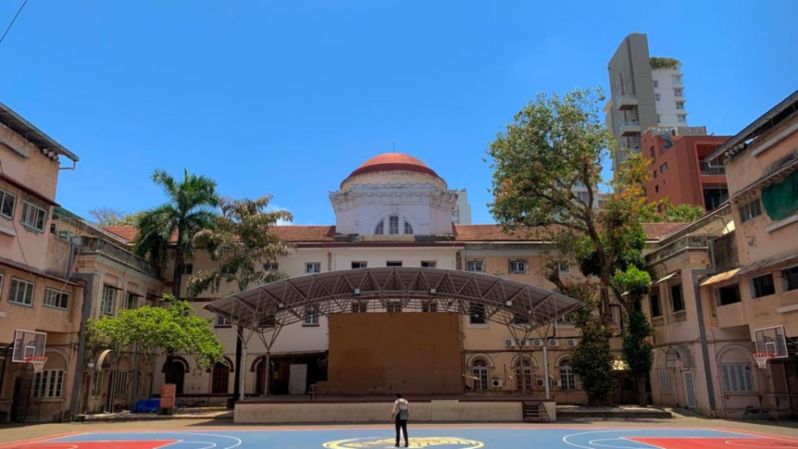 a man standing in front of a basketball court